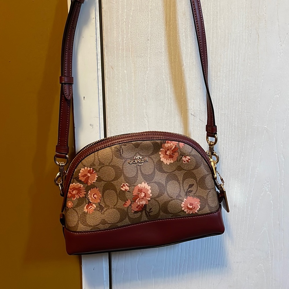This is a small coach crossbody purse with flowers 🌸 in great condition.